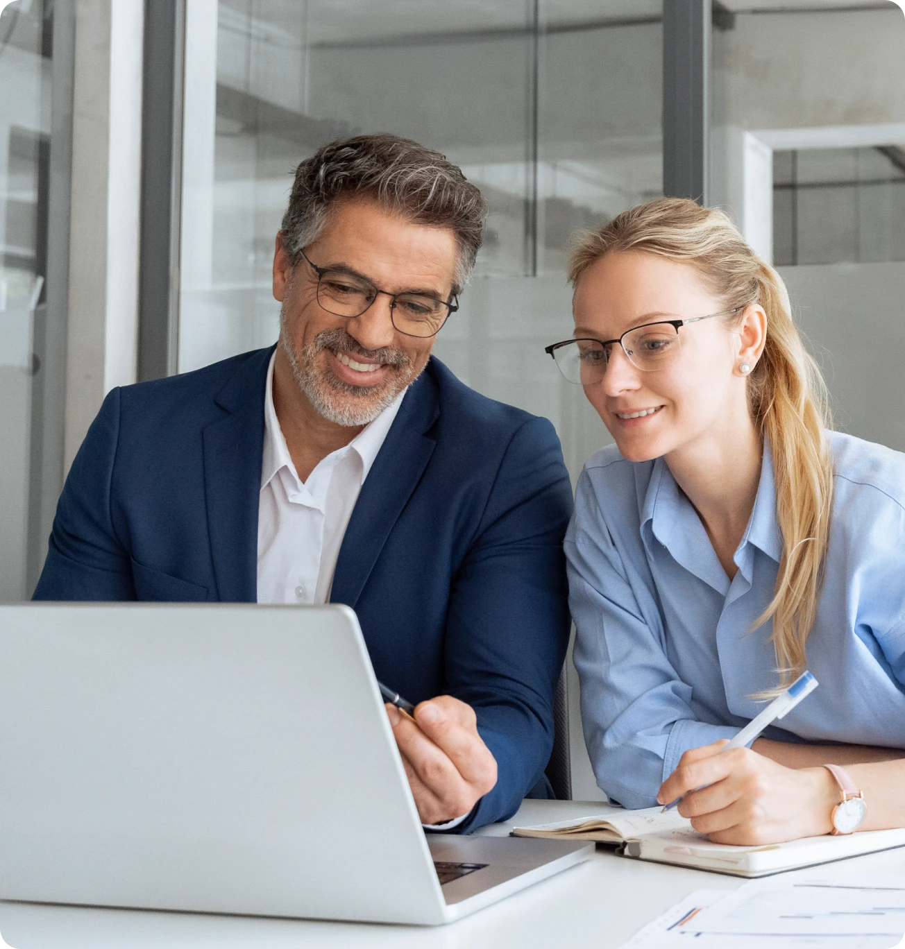 Colleagues discussing work at laptop